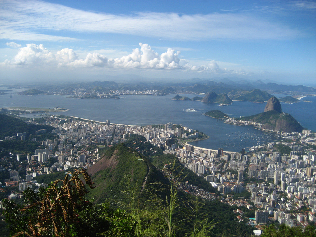 Panoramic view over Rio de Janeiro from a hillside, looking across the bay toward Sugarloaf Mountain.